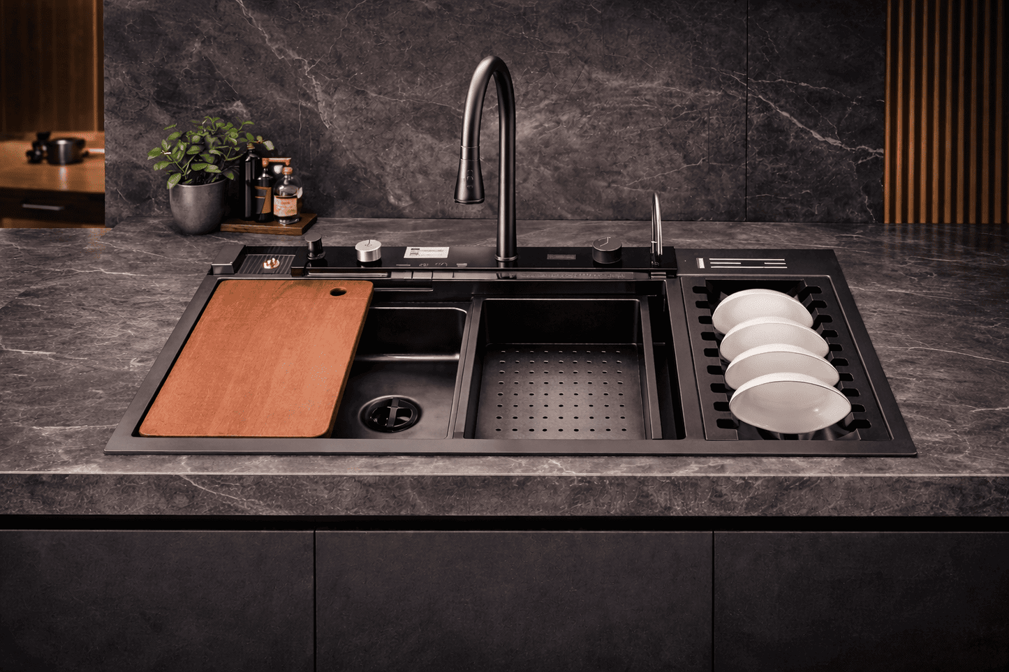 Modern kitchen sink with a cutting board and dishes on a dark countertop.
