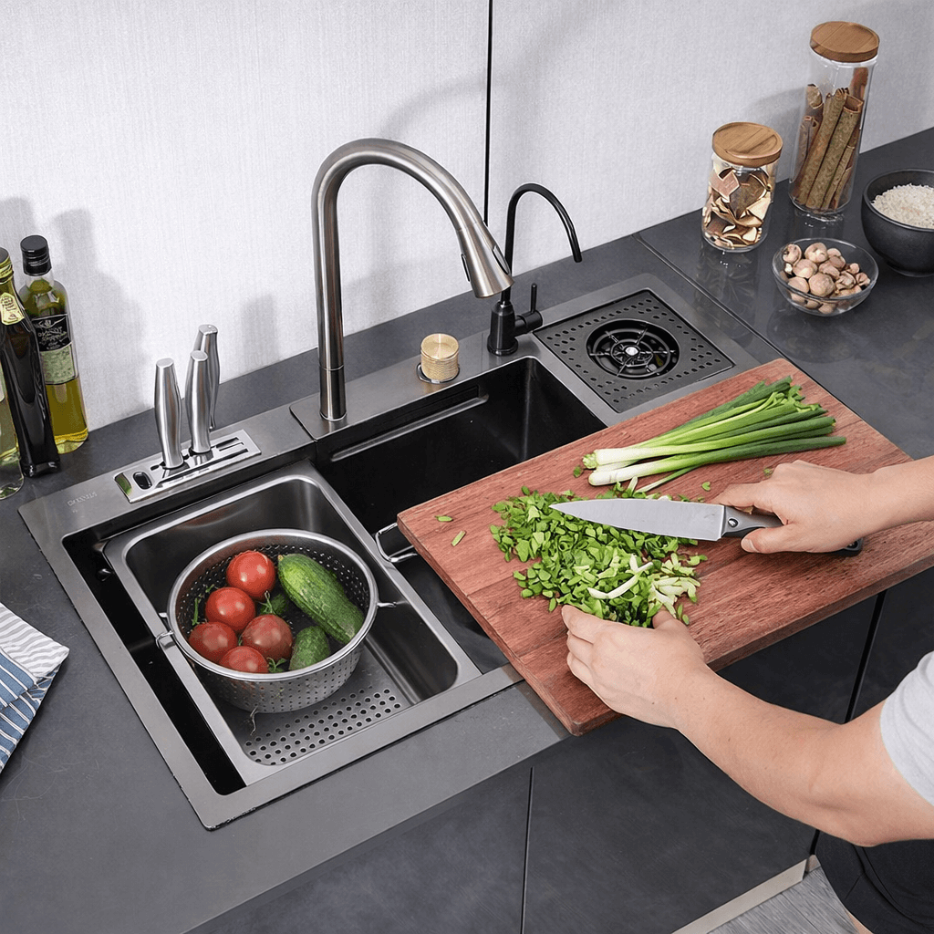 Person chopping vegetables on a cutting board next to a kitchen sink with a modern faucet.
