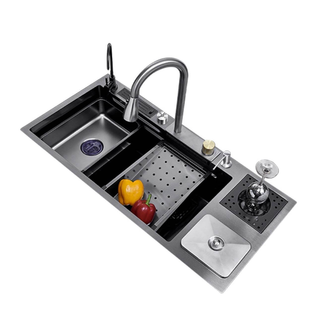 Stainless steel kitchen sink with faucet and accessories on a white background