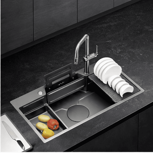 Modern kitchen sink with faucet and dishes on a dark countertop