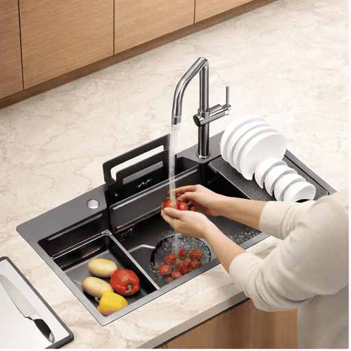 Person washing vegetables in a modern kitchen sink with a faucet and dish rack.