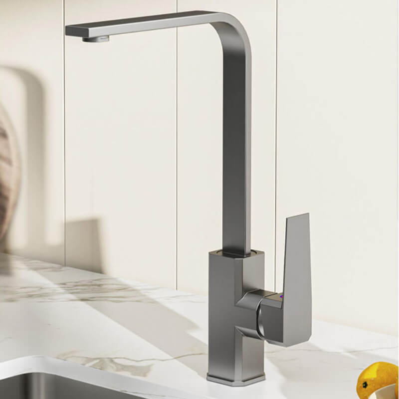 Modern kitchen faucet on a white countertop with a blurred background