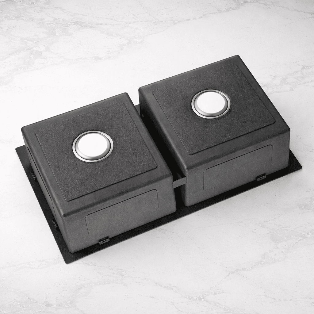 Two black square objects with circular cutouts on a light gray surface