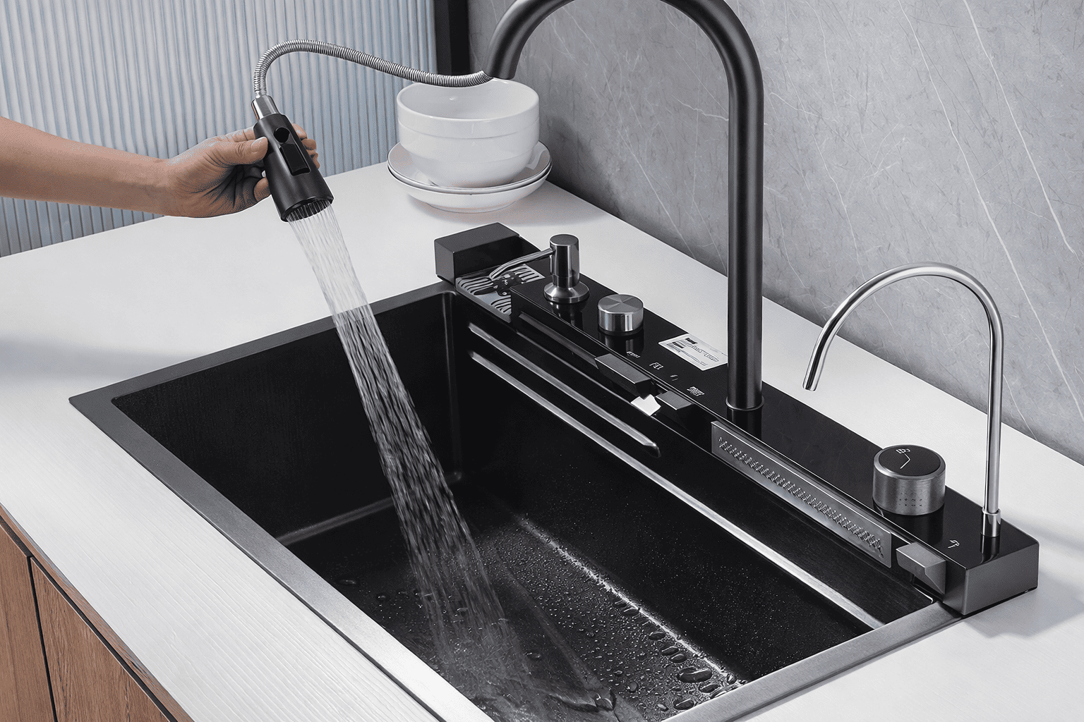 Black kitchen sink with running water from a faucet in a modern kitchen setting.